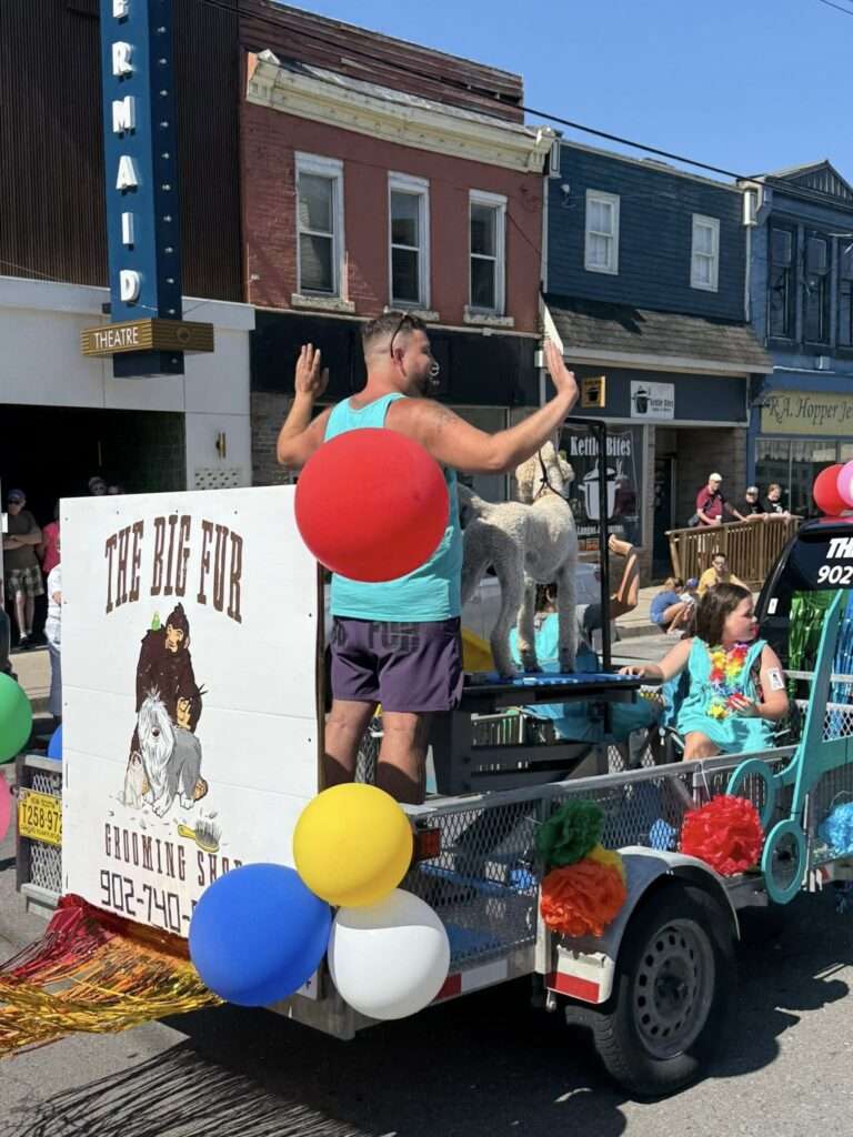 The Big Fur Grooming Shop float, decorated with balloons and colorful streamers, wins Best Float at the Avon River Days Grand Street Parade in downtown Windsor, Nova Scotia.